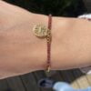 image00001 Bracelet Co88 France en acier inoxydable doré et perles marrons, pampille dorée